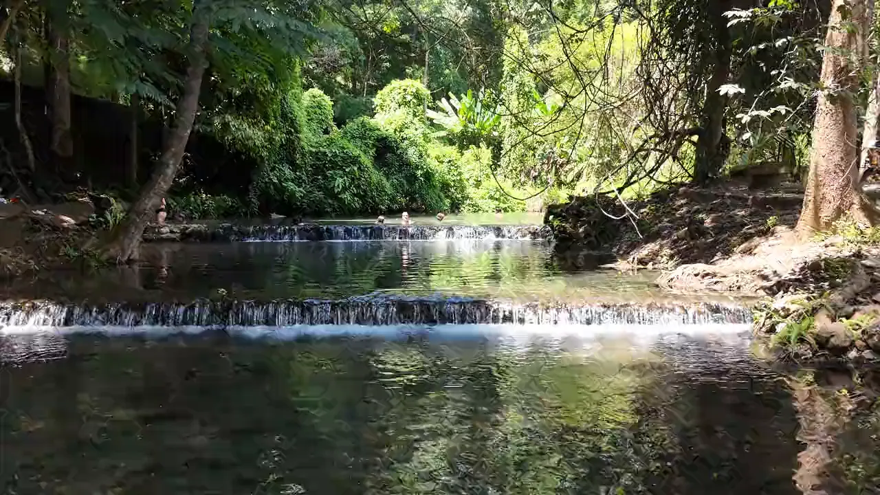 Sai Ngam’s clear pools under the trees, the water spilling over a low weir