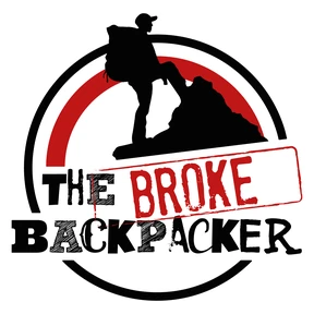 The Broke Backpacker’s logo: a backpacker climbing a peak inside a red and black circle