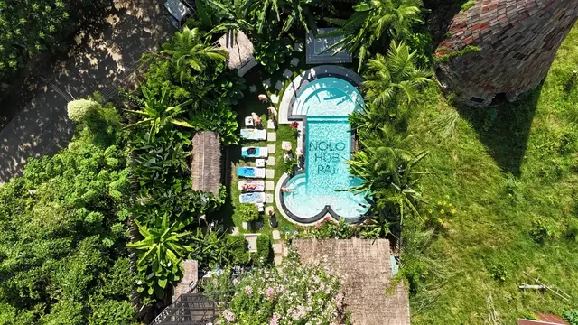Nolo Hub’s pool from above, NOLO HUB PAI in tiles along its length