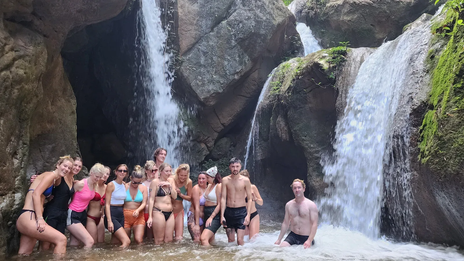 A group at the foot of Hua Chang’s two falls, under the rock headwall