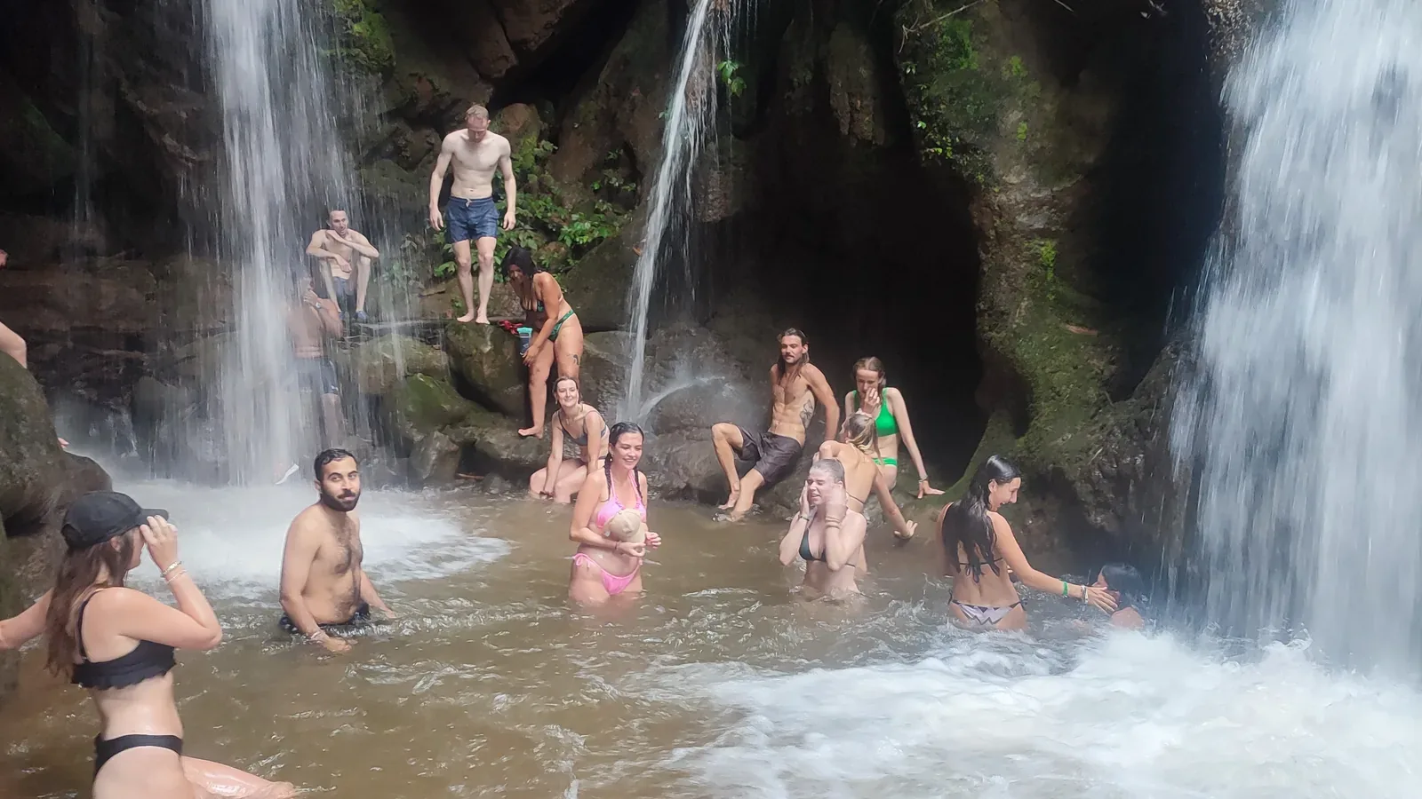 Swimmers in the pool beneath Hua Chang’s falls in the wet season
