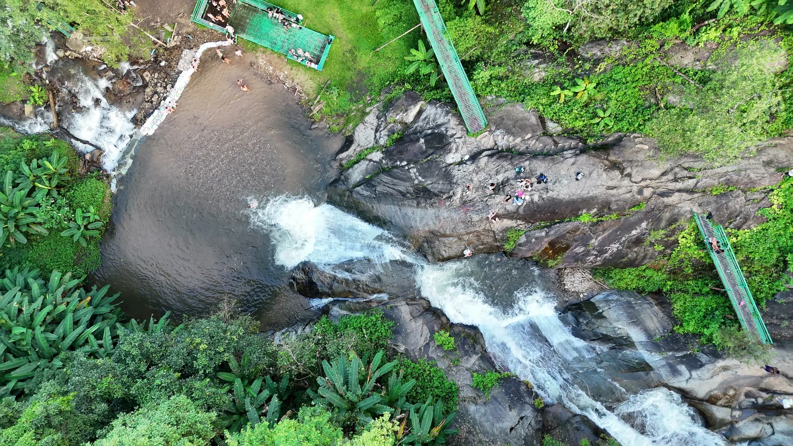 Water pouring over the smooth rock slides at Mor Pang, from above
