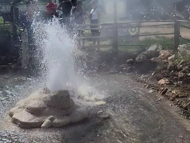 Boiling water shooting up from the fenced well at Muang Rae