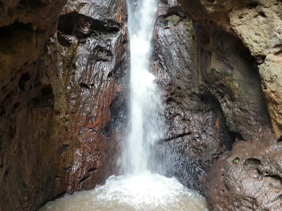 Pam Bok Waterfall dropping into its pool between the gorge walls