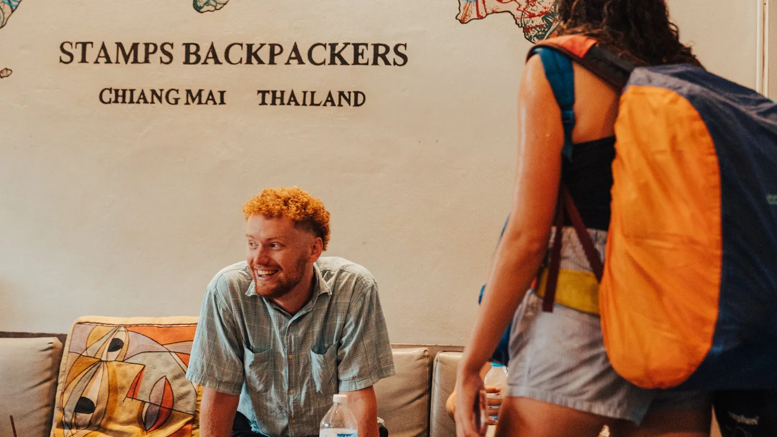 A guest checking in at Stamps Backpackers in Chiang Mai