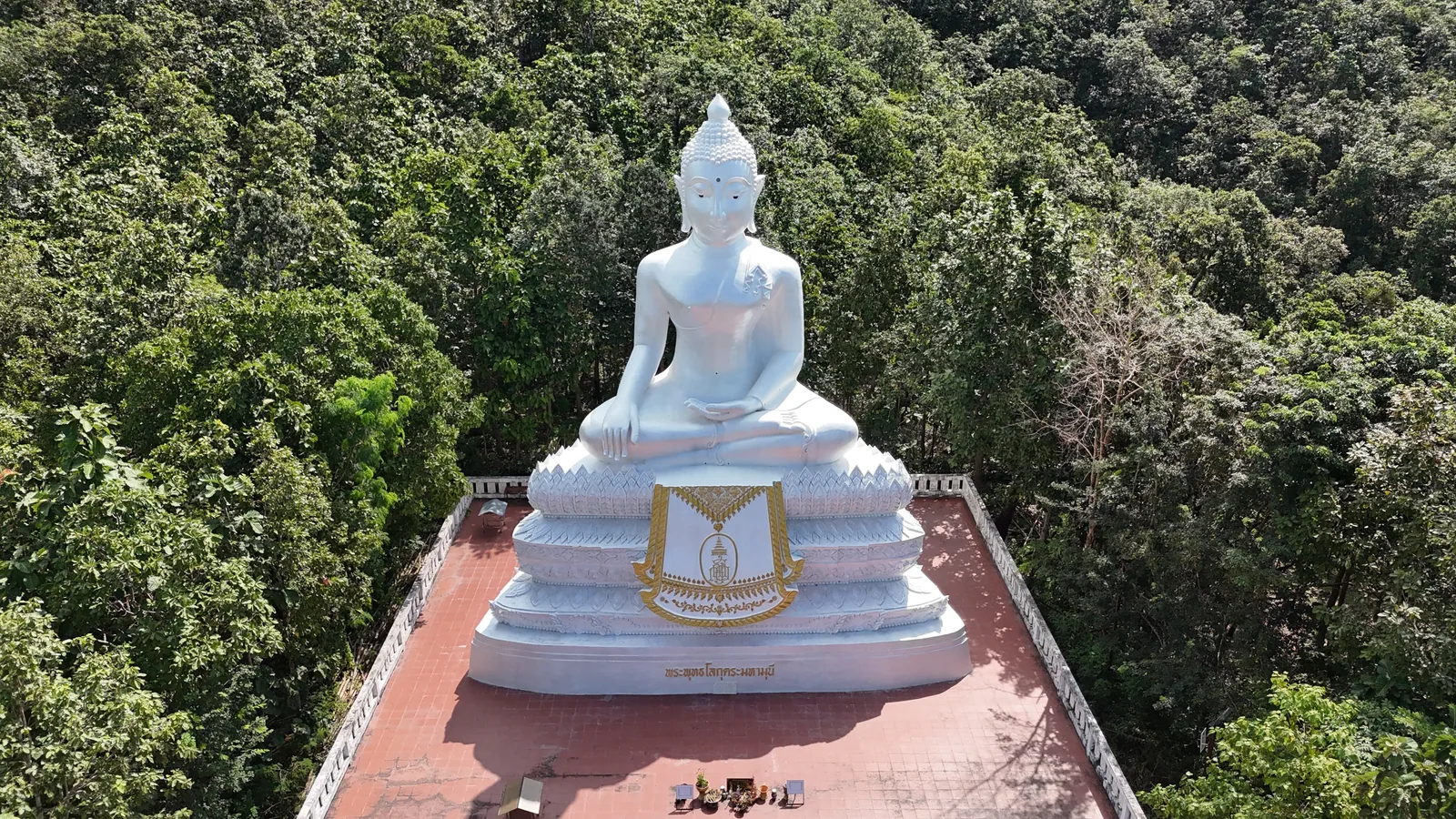 The White Buddha on its terrace, surrounded by forest